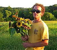 Carden Willis holding flowers at A Place on Earth CSA Farm